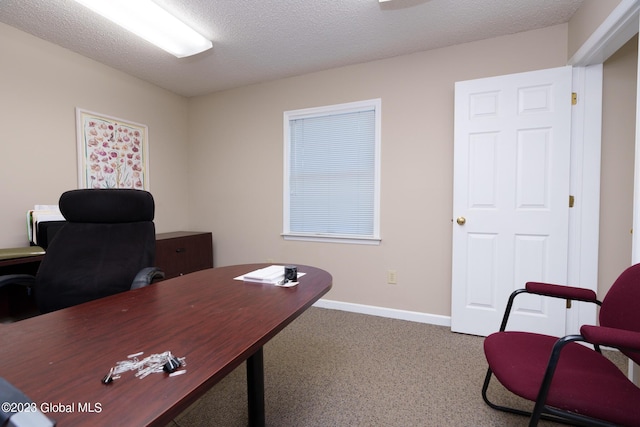 carpeted home office with a textured ceiling