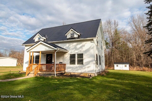 view of front of house featuring covered porch, a front yard, and a storage unit