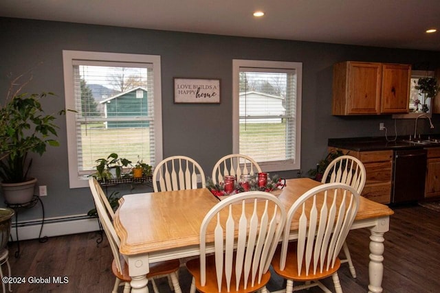 dining area with sink, dark wood-type flooring, a wealth of natural light, and a baseboard radiator