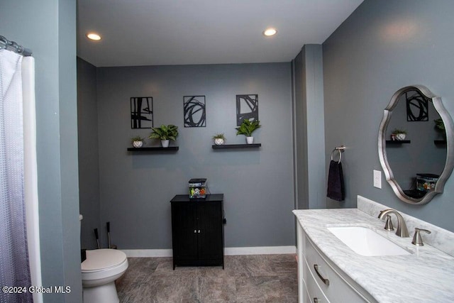 bathroom featuring tile patterned flooring, vanity, and toilet