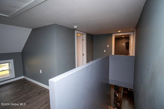 corridor featuring dark hardwood / wood-style floors and lofted ceiling