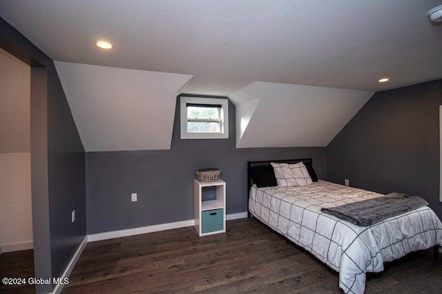 bedroom with dark hardwood / wood-style floors and vaulted ceiling