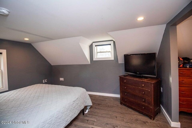 bedroom with lofted ceiling and dark wood-type flooring