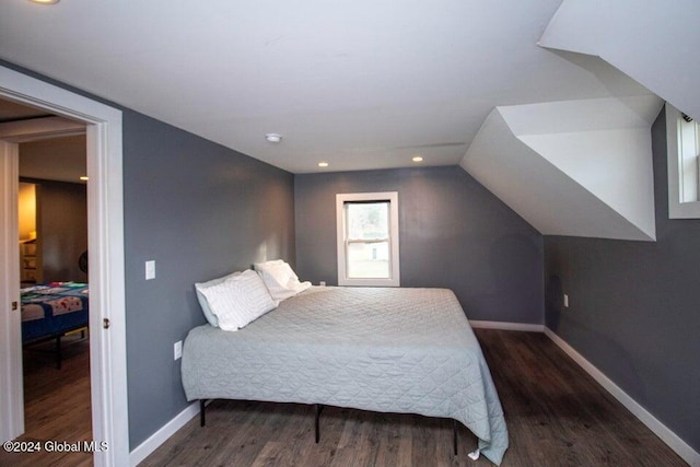 bedroom featuring dark hardwood / wood-style flooring and vaulted ceiling