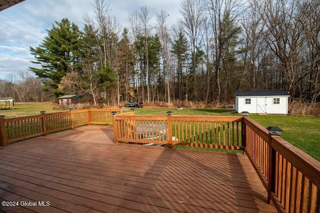 wooden deck with a shed and a lawn