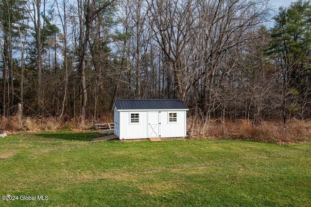 view of outbuilding with a lawn