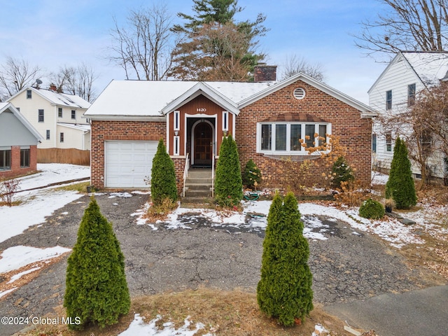 bungalow-style home with a garage