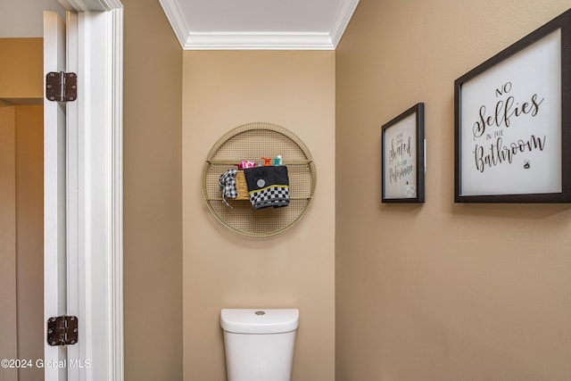 bathroom featuring toilet and crown molding