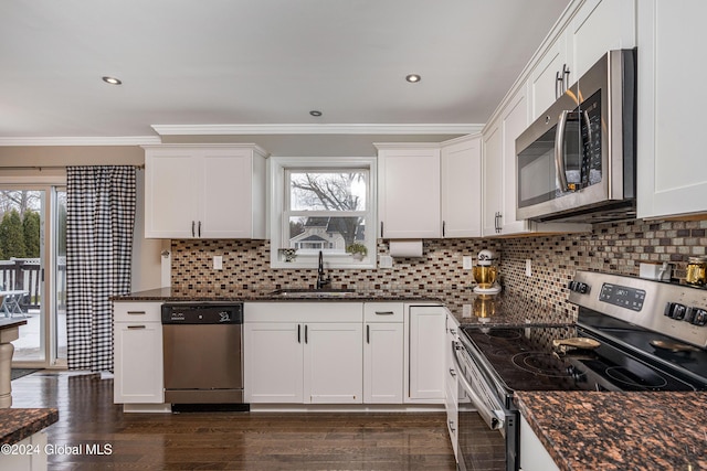 kitchen with sink, white cabinets, dark hardwood / wood-style floors, and appliances with stainless steel finishes