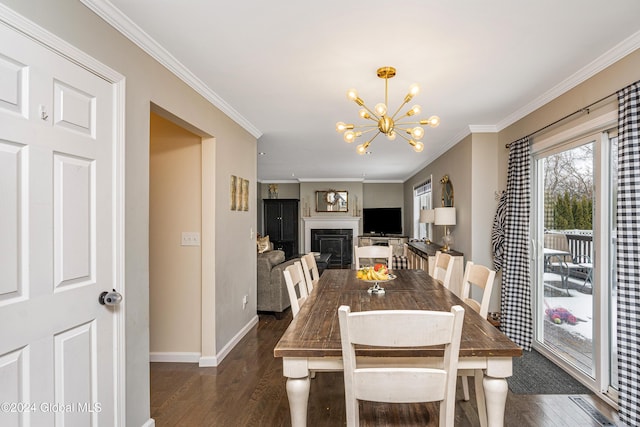 dining room featuring dark hardwood / wood-style floors, crown molding, and an inviting chandelier