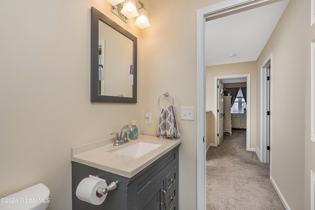 bathroom featuring vanity and toilet