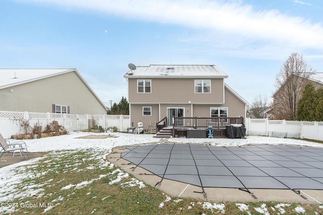 snow covered property with a swimming pool side deck