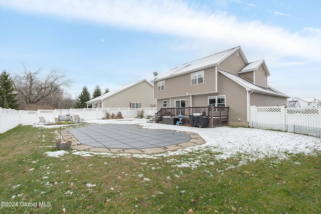 rear view of property with a lawn, a swimming pool side deck, and a patio