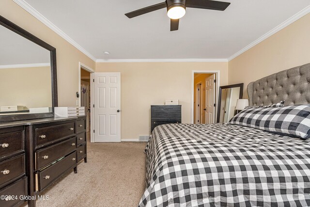 carpeted bedroom featuring ceiling fan and ornamental molding