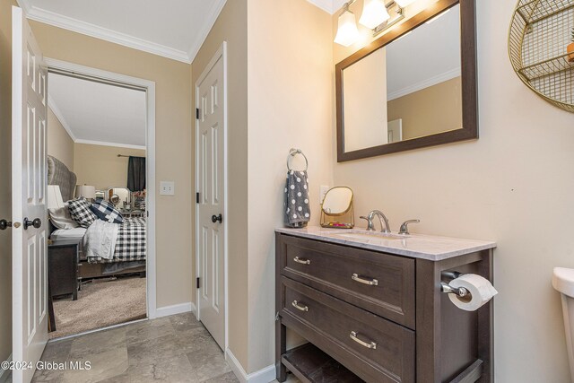 bathroom with vanity, toilet, and crown molding