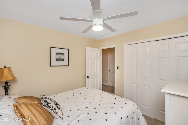 carpeted bedroom featuring ceiling fan and a closet