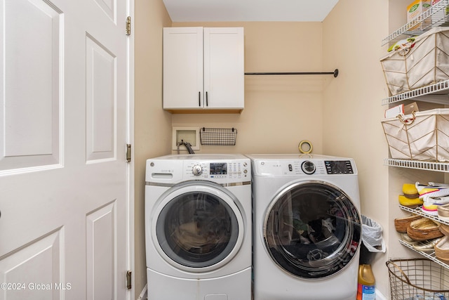 laundry area with cabinets and washing machine and dryer