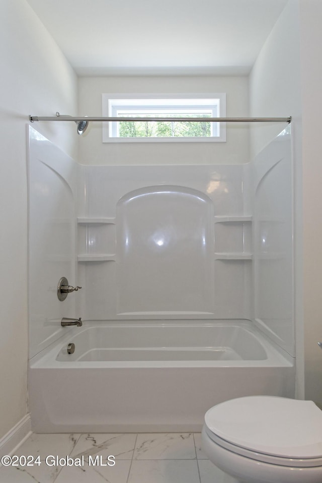 bathroom with bathing tub / shower combination and toilet