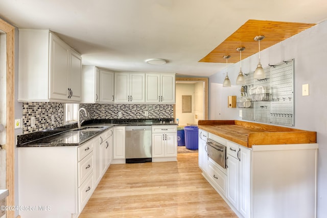 kitchen featuring sink, white cabinets, stainless steel dishwasher, and decorative light fixtures