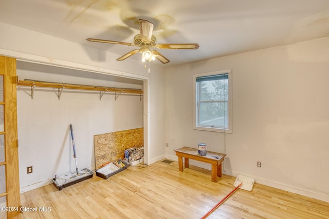 interior space featuring ceiling fan, a closet, and light wood-type flooring