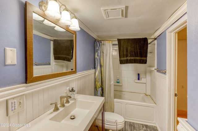 full bathroom with crown molding, wood-type flooring, toilet, shower / bath combo with shower curtain, and vanity