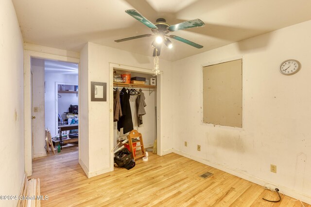 bedroom with ceiling fan, a closet, and light wood-type flooring