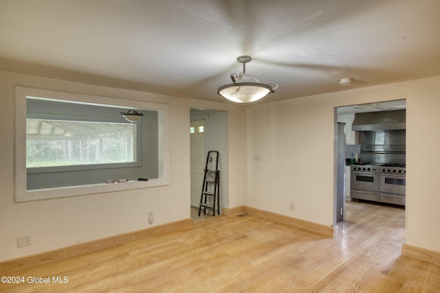 spare room with light wood-type flooring