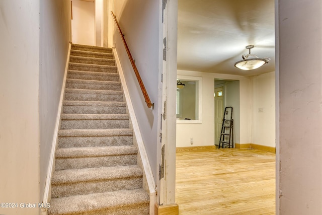 stairs featuring hardwood / wood-style floors