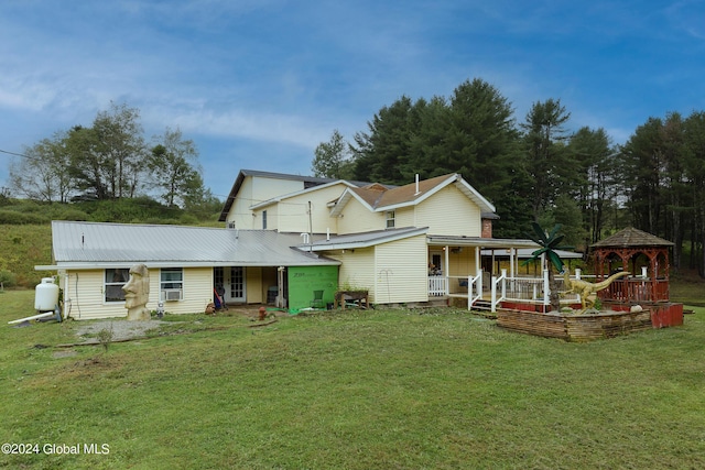 back of house with a porch, a yard, and a gazebo