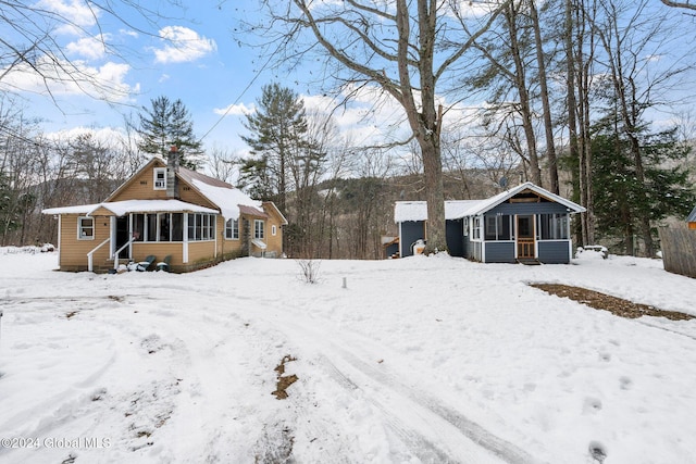 view of snow covered rear of property