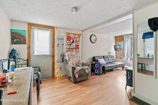 interior space featuring a textured ceiling and light hardwood / wood-style floors