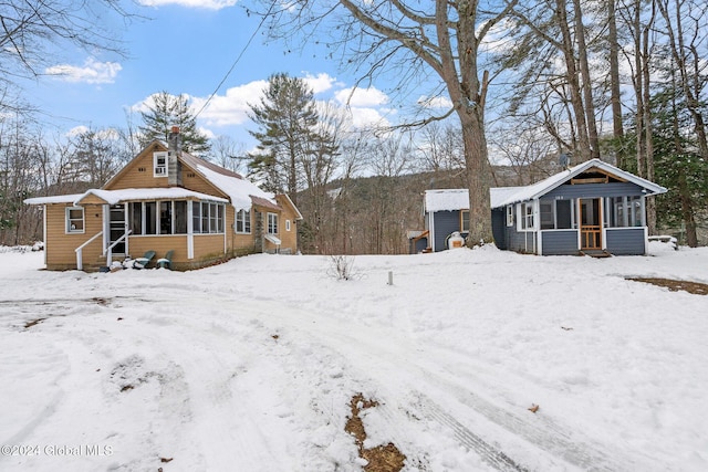 view of snow covered rear of property