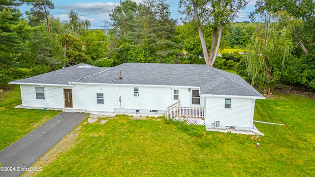 back of property featuring a lawn