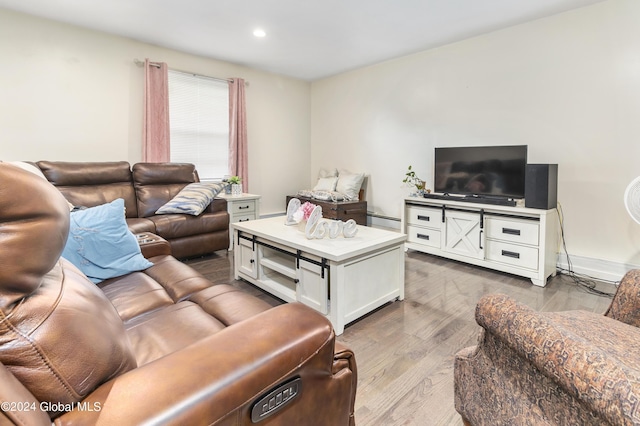 living room with light hardwood / wood-style floors and baseboard heating