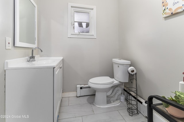 bathroom with vanity, toilet, and baseboard heating