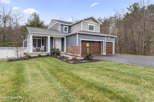 front of property with a front lawn, covered porch, and a garage