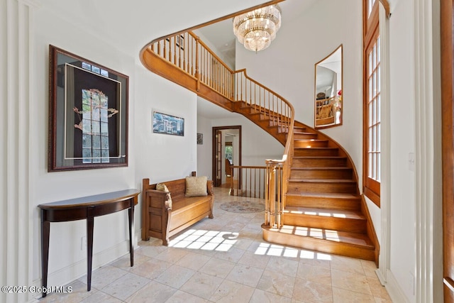 staircase with tile patterned floors and a notable chandelier