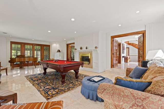 recreation room featuring a premium fireplace and pool table