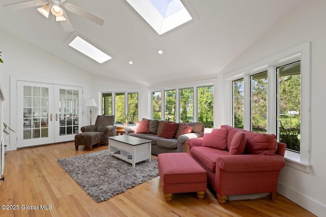 sunroom / solarium with ceiling fan, french doors, and lofted ceiling