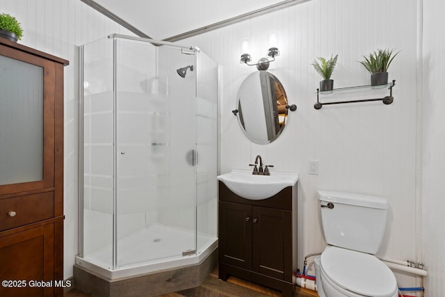 bathroom featuring vanity, an enclosed shower, and toilet