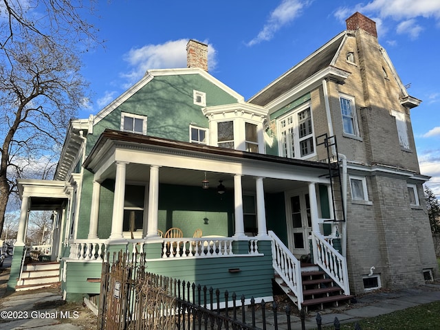 rear view of property with covered porch