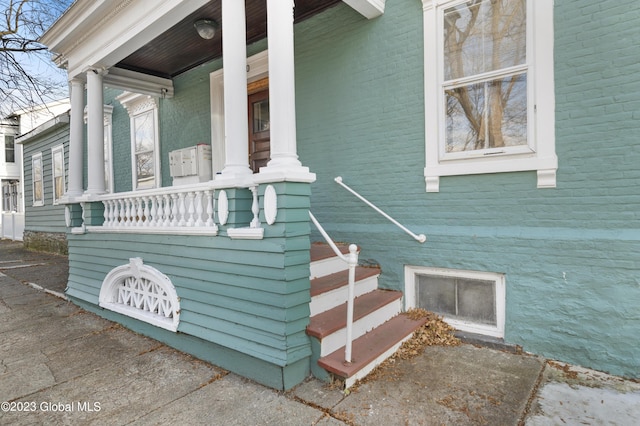 view of side of property featuring covered porch