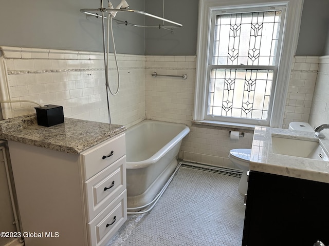 bathroom featuring a bathtub, plenty of natural light, and tile walls