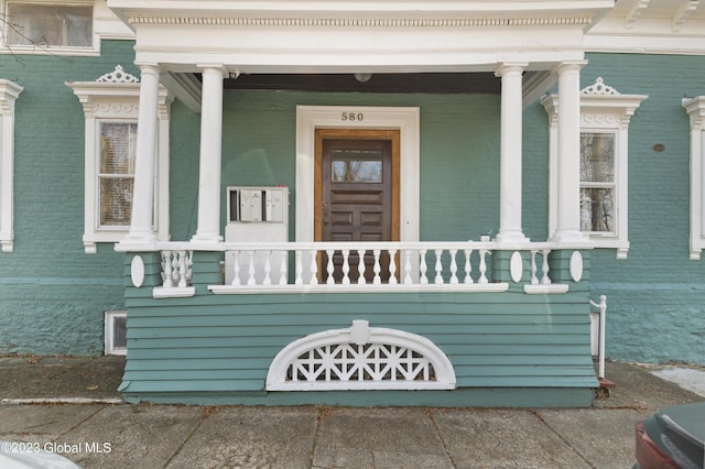 view of exterior entry featuring a porch