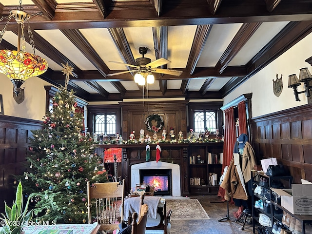 interior space with beam ceiling, crown molding, ceiling fan, and a healthy amount of sunlight