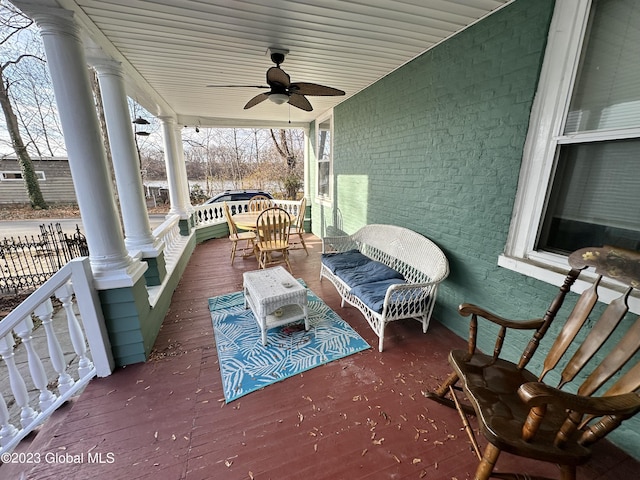 wooden deck with ceiling fan and covered porch