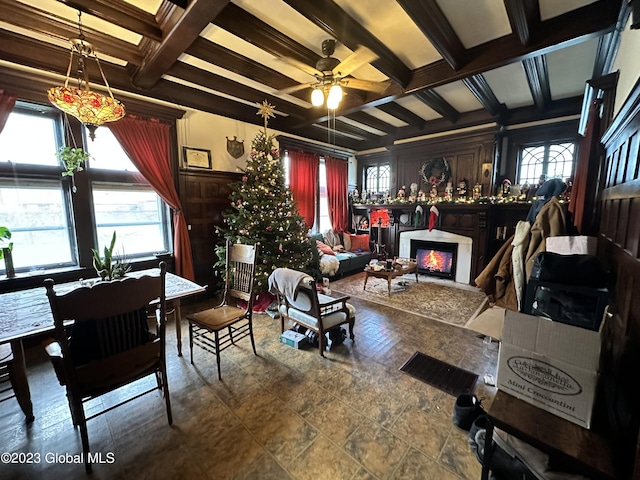 living room with beam ceiling, ceiling fan, and plenty of natural light