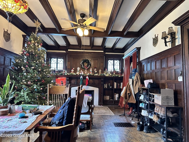 interior space featuring crown molding, beamed ceiling, and ceiling fan