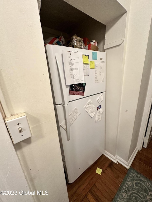 details with white refrigerator and hardwood / wood-style flooring