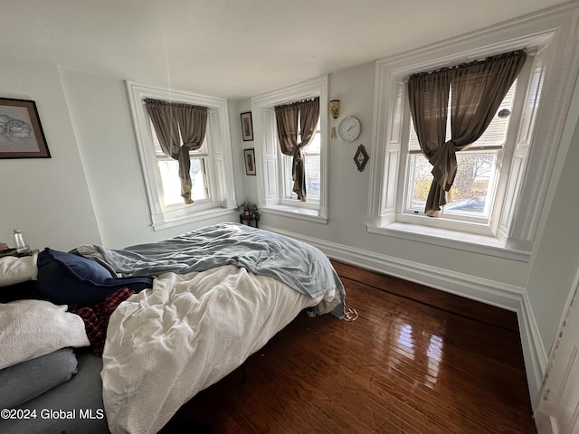 bedroom with dark hardwood / wood-style floors